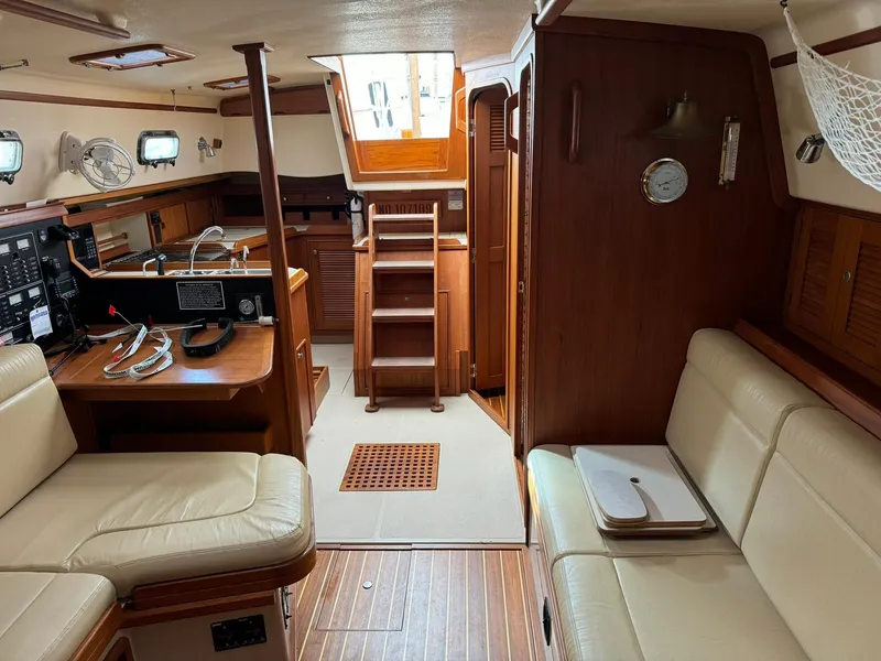 Slide: The Image of Interior of 1998 Island Packet 40 sailboat with wood finish and seating area. - 27