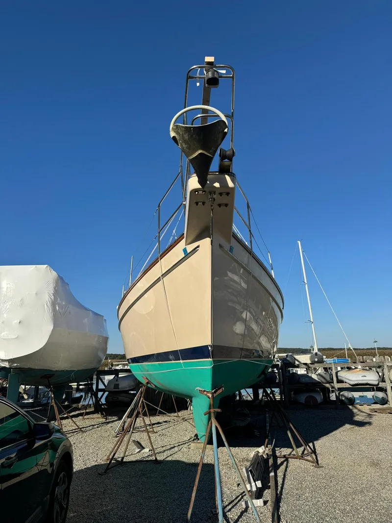 Slide: The Image of 1998 Island Packet 40 sailboat on dry dock under clear blue sky. - 3
