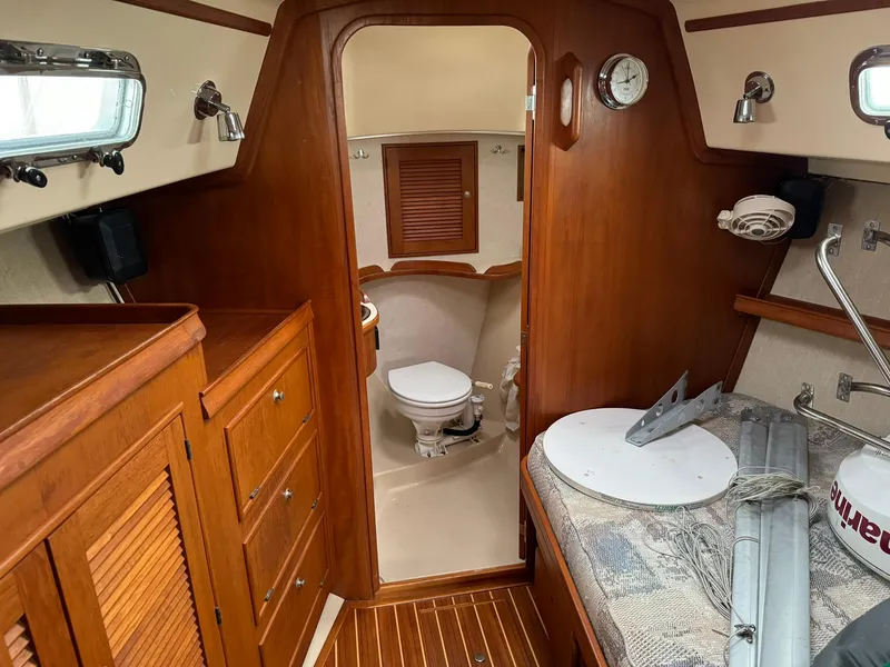 Slide: The Image of Interior of 1998 Island Packet 40 sailboat with wooden cabinetry and compact bathroom. - 30