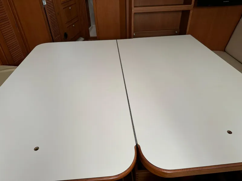 Slide: The Image of Interior table of 1998 Island Packet 40 sailboat, featuring a foldable design. - 31