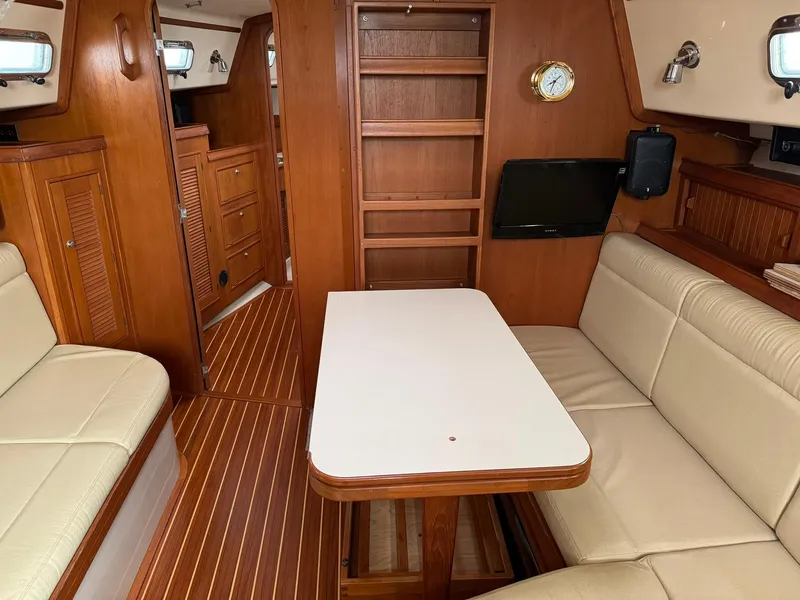 Slide: The Image of Interior of 1998 Island Packet 40 sailboat with wood finish and beige seating. - 32