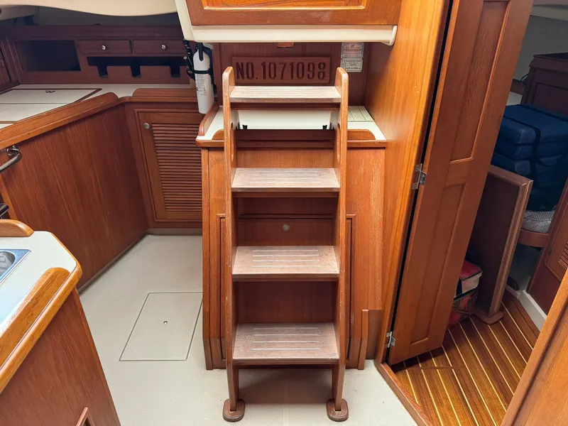 Slide: The Image of Interior of 1998 Island Packet 40 sailboat with wooden steps and cabinetry. - 33