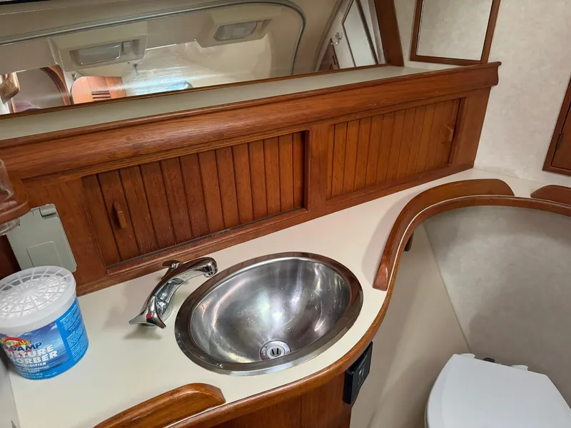 Slide: The Image of Island Packet 40 yacht bathroom with wooden cabinets and stainless steel sink, 1998 model. - 35
