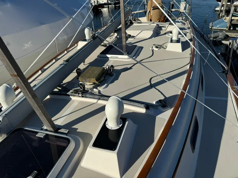 Slide: The Image of 1998 Island Packet 40 sailboat deck with rigging and hatches, docked at marina. - 6