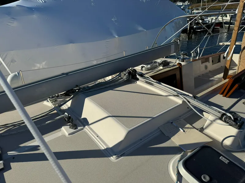 Slide: The Image of 1998 Island Packet 40 sailboat deck with rigging and covered equipment. - 9