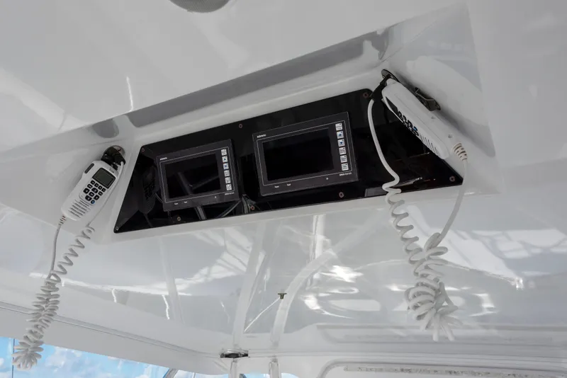 Slide: The Image of 1963 Whiticar 54 Sportfisherman boat dashboard with communication devices and controls. - 12