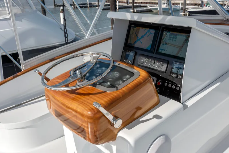 Slide: The Image of 1963 Whiticar 54 Sportfisherman helm with wooden steering wheel and modern navigation displays. - 13