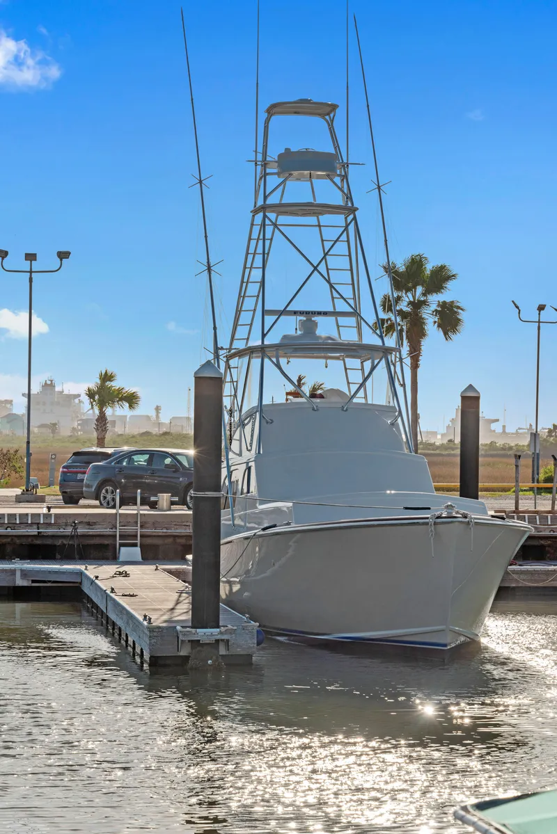 Slide: The Image of 1963 Whiticar 54 Sportfisherman docked at marina under clear blue sky. - 2