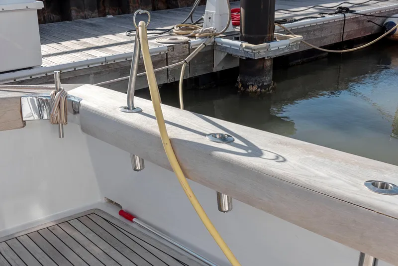 Slide: The Image of 1963 Whiticar 54 Sportfisherman docked, showcasing deck details and mooring lines. - 23