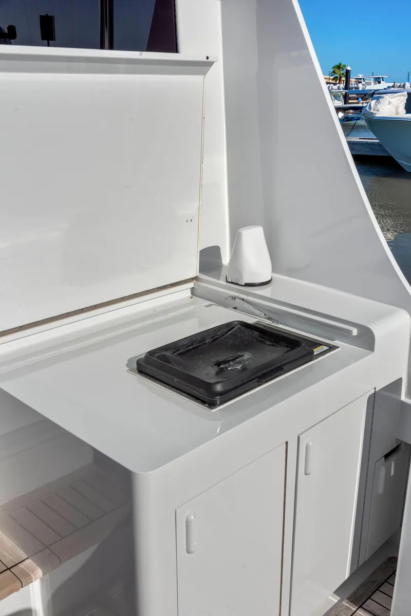 Slide: The Image of 1963 Whiticar 54 Sportfisherman boat kitchen with stove and storage cabinets. - 27