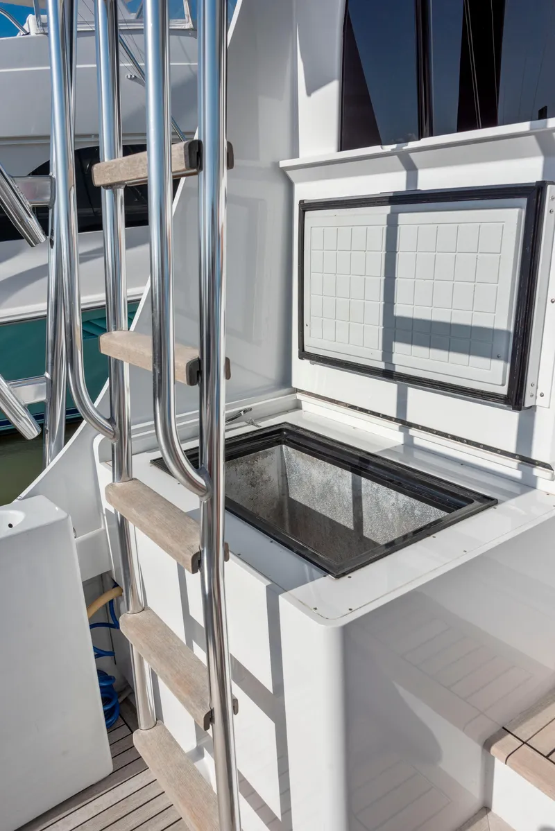 Slide: The Image of 1963 Whiticar 54 Sportfisherman boat deck with ladder and storage compartment. - 28