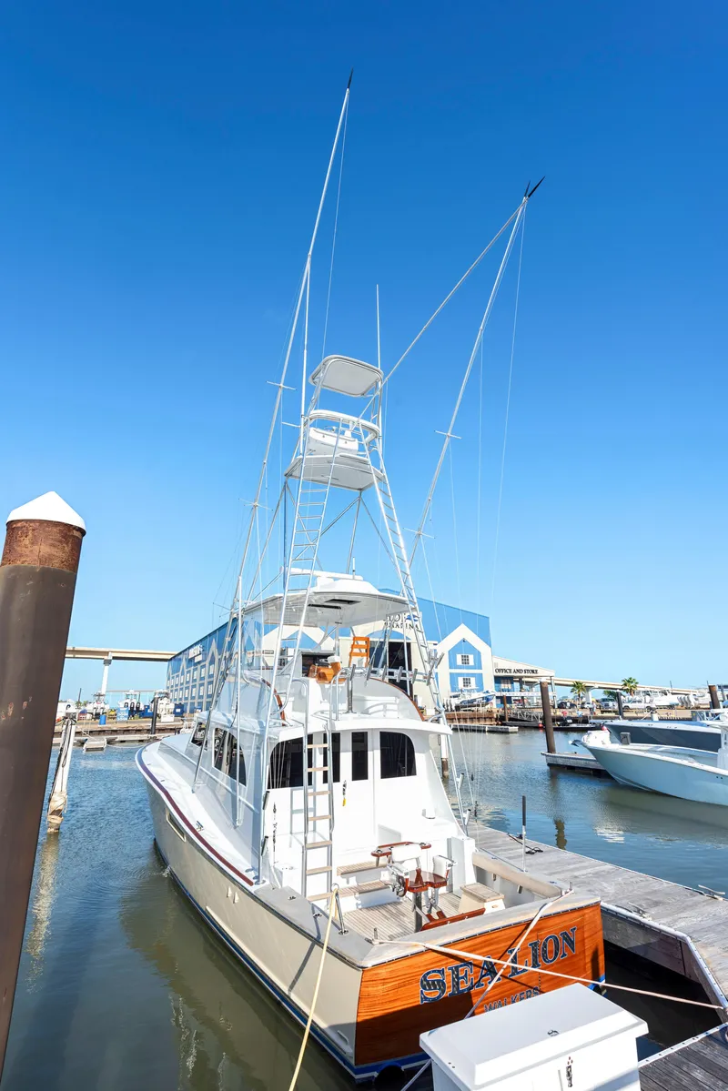 Slide: The Image of 1963 Whiticar 54 Sportfisherman docked at marina under clear blue sky. - 3