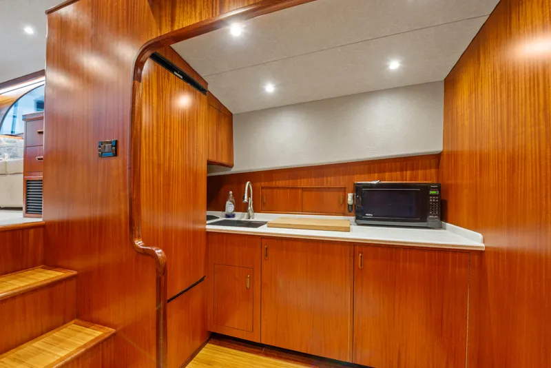 Slide: The Image of 1963 Whiticar 54 Sportfisherman interior with wood cabinetry and modern kitchen amenities. - 34