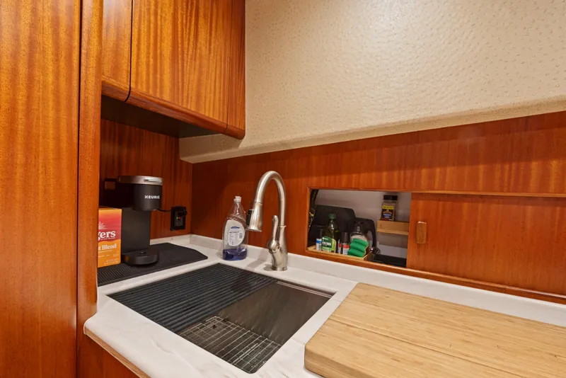Slide: The Image of 1963 Whiticar 54 Sportfisherman kitchen with wooden cabinetry and modern sink. - 37