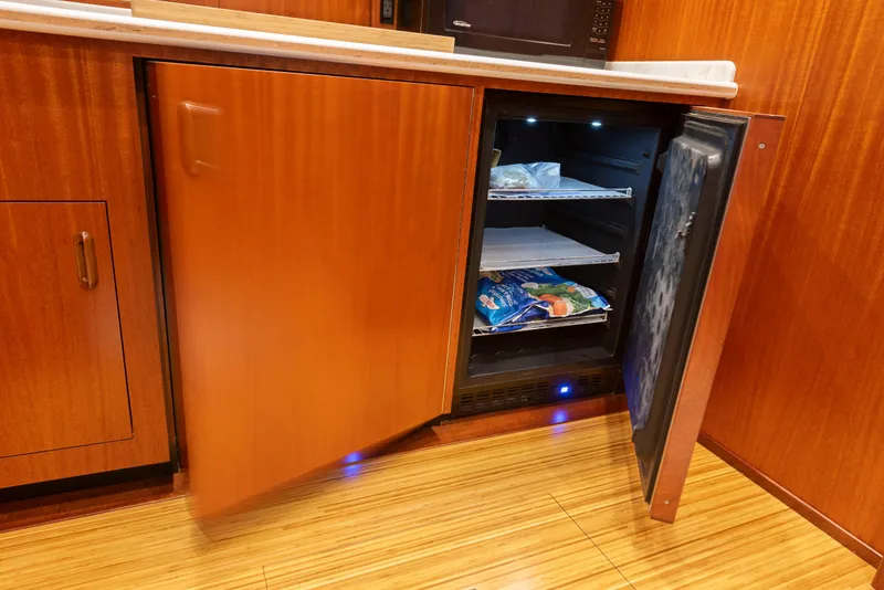 Slide: The Image of Open mini fridge in 1963 Whiticar 54 Sportfisherman yacht kitchen, wooden cabinetry. - 38