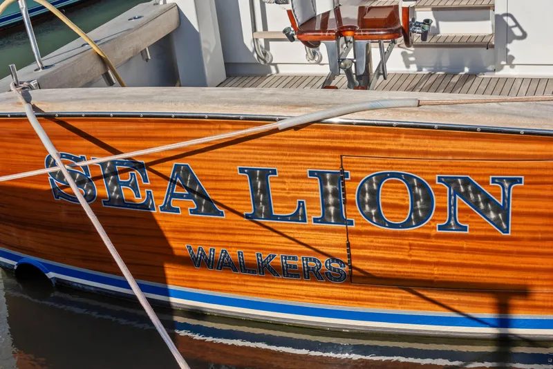 Slide: The Image of 1963 Whiticar 54 Sportfisherman "Sea Lion" docked, showcasing wooden hull design. - 4