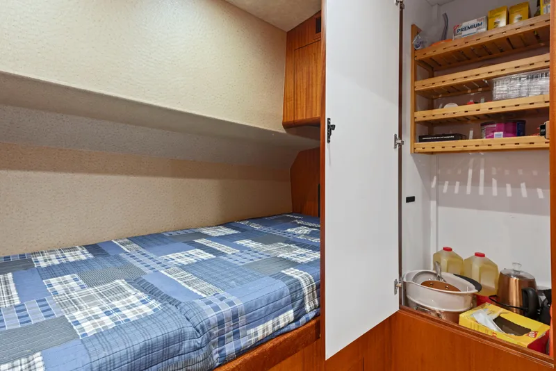 Slide: The Image of Cozy cabin interior of 1963 Whiticar 54 Sportfisherman with bed and storage shelves. - 40
