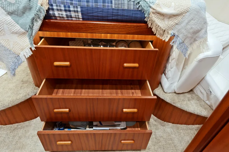 Slide: The Image of Wooden drawers in a 1963 Whiticar 54 Sportfisherman cabin, showcasing storage space. - 47
