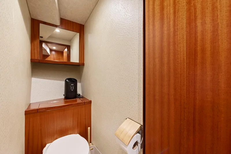 Slide: The Image of 1963 Whiticar 54 Sportfisherman bathroom with wood paneling and mirror. - 48
