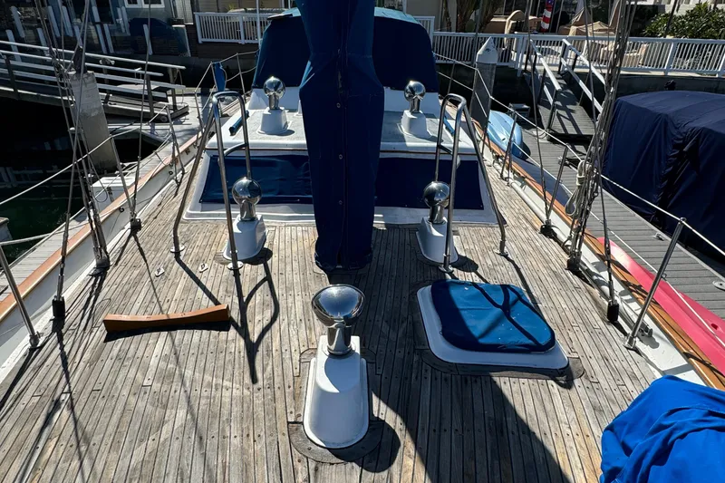 Slide: The Image of 1984 Transpacific Marine Ketch deck with wooden finish and nautical equipment. - 19