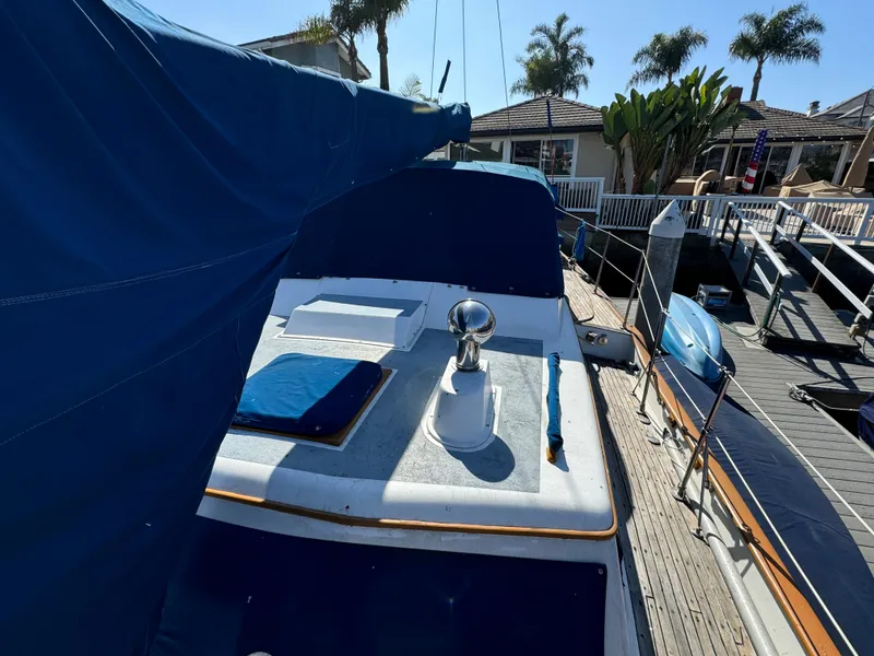 Slide: The Image of 1984 Transpacific Marine Ketch docked, featuring blue covers and deck details. - 21