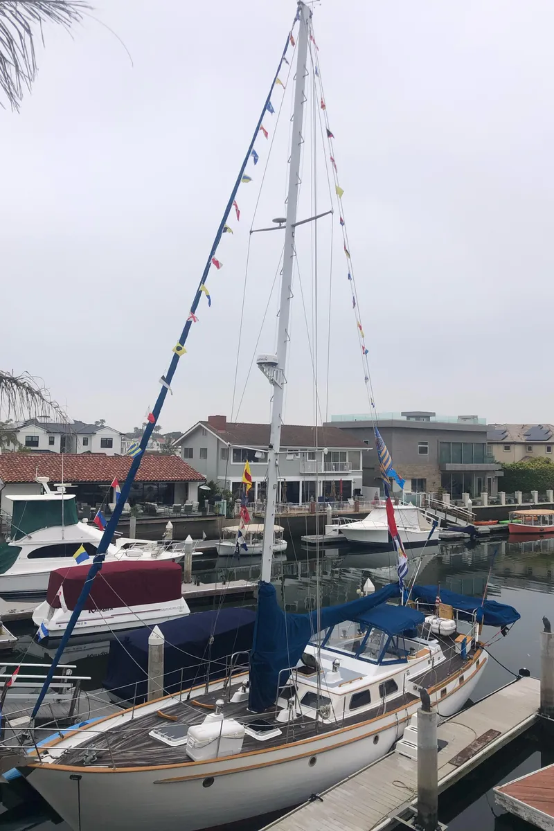 Slide: The Image of 1984 Transpacific Marine Ketch docked in a marina, surrounded by other boats. - 3