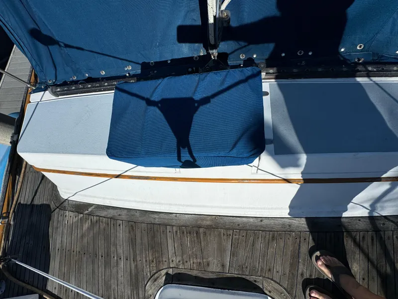 Slide: The Image of 1984 Transpacific Marine Ketch deck with blue canvas and wooden flooring. - 31