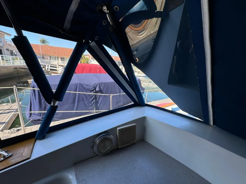 Slide: The Image of 1984 Transpacific Marine Ketch interior view with marina backdrop. - 36