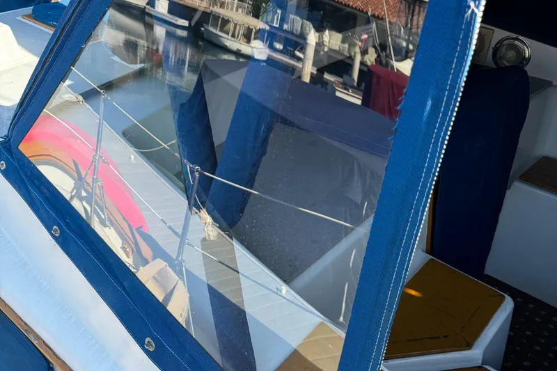 Slide: The Image of 1984 Transpacific Marine Ketch with blue canvas, docked at marina. - 39