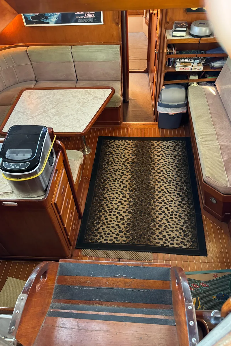 Slide: The Image of Interior of 1984 Transpacific Marine Ketch with cozy seating and leopard-print rug. - 47