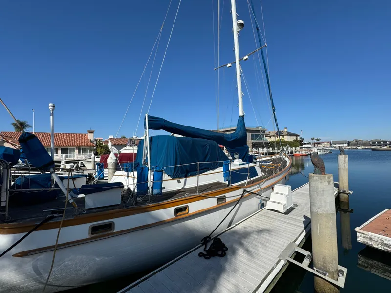 Slide: The Image of 1984 Transpacific Marine Ketch docked at marina under clear blue sky. - 7