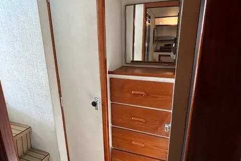 Slide: The Image of 1977 Bertram 35 Convertible interior with wooden drawers and mirror. - 15