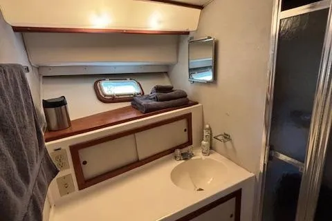 Slide: The Image of 1977 Bertram 35 Convertible yacht bathroom with sink, mirror, and shower. - 18
