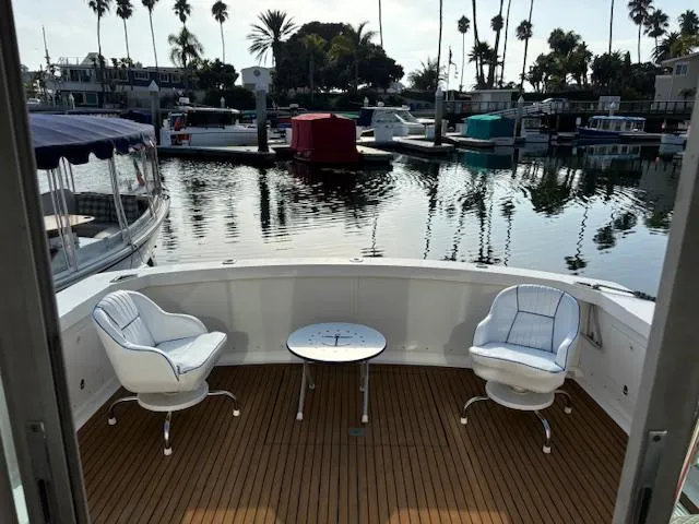 Slide: The Image of 1977 Bertram 35 Convertible yacht deck with chairs and table, docked in a marina. - 20