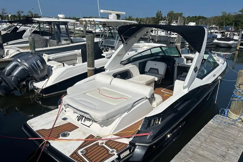 The Image of 2015 Monterey 288 Super Sport boat docked at marina, featuring sleek design and spacious seating. - 0