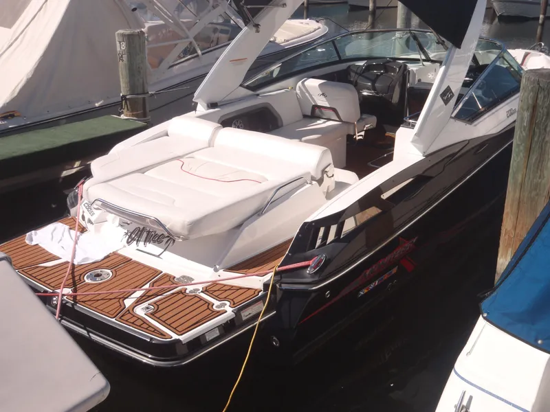 Slide: The Image of 2015 Monterey 288 Super Sport boat docked, featuring sleek design and spacious seating. - 11