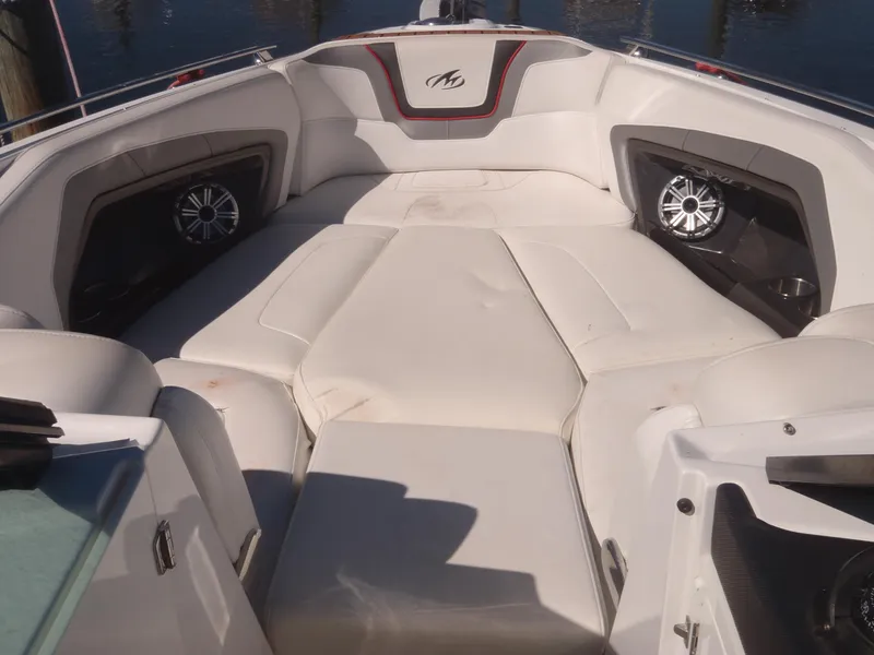 Slide: The Image of 2015 Monterey 288 Super Sport boat interior with cushioned seating and speakers. - 13