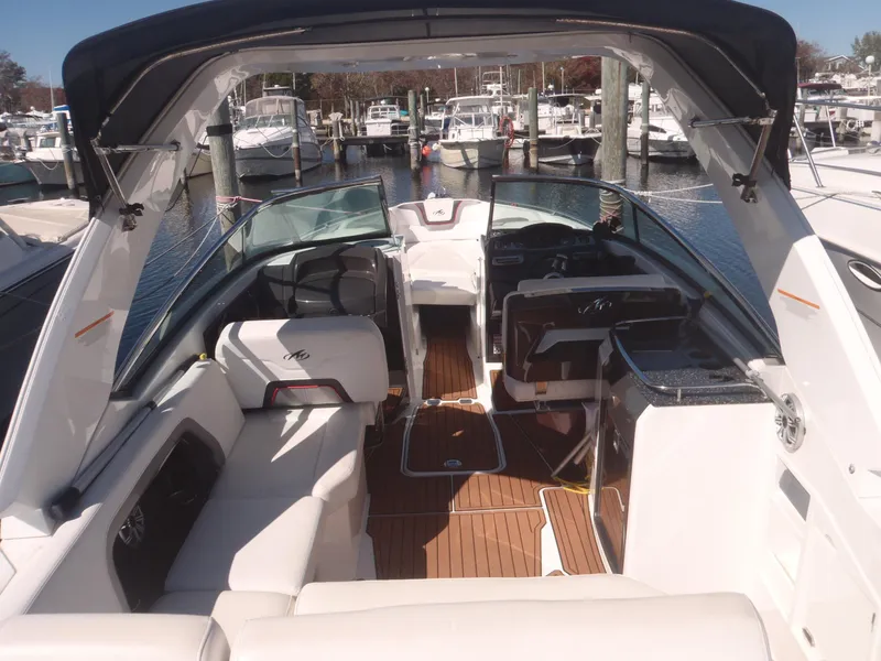 Slide: The Image of 2015 Monterey 288 Super Sport boat interior at marina, featuring spacious seating and sleek design. - 8