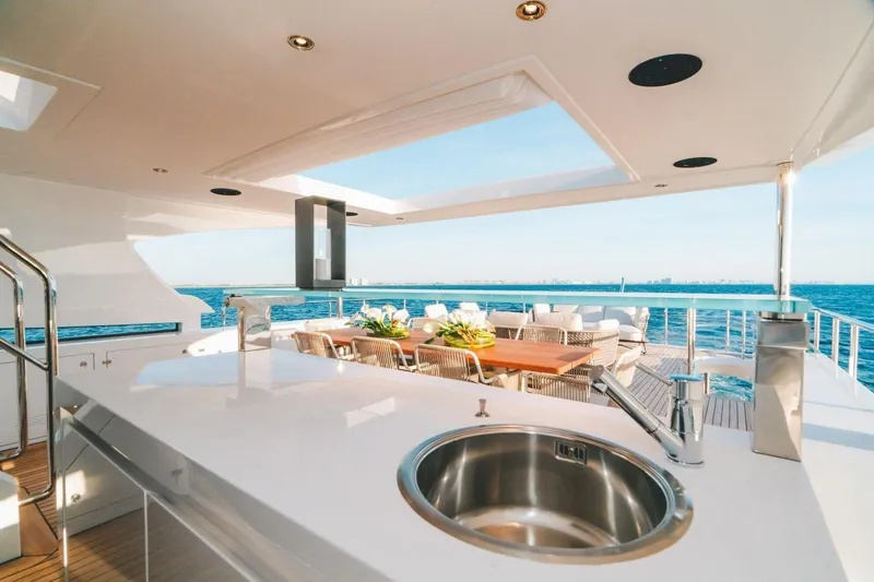Slide: The Image of Luxurious Benetti Delfino 95 yacht deck with dining area and ocean view, 2020 model. - 24