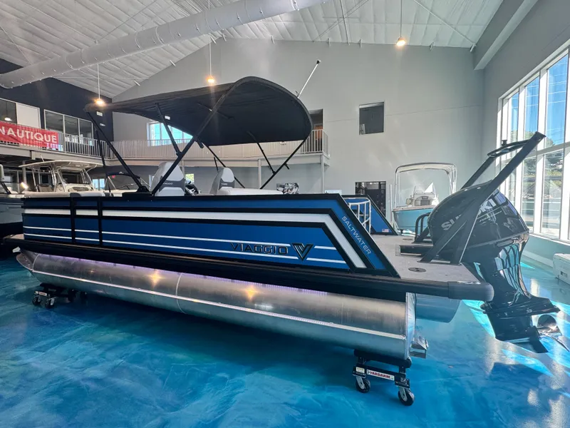 Slide: The Image of 2025 Viaggio Lago Z-S pontoon boat in showroom with sleek design and modern features. - 2