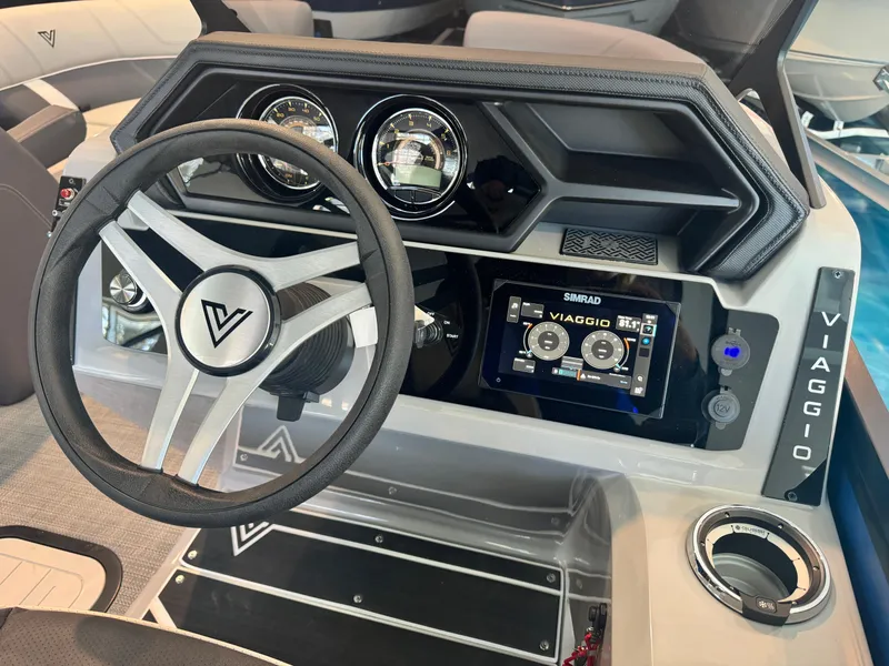 Slide: The Image of 2025 Viaggio Lago Z-S boat dashboard with steering wheel and digital display. - 6