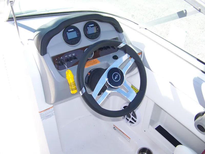 Slide: The Image of 2024 Chaparral 19 SSi OB boat dashboard with steering wheel and gauges. - 5