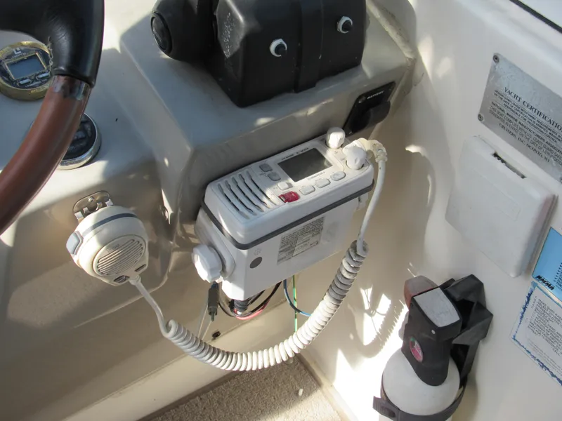 Slide: The Image of 2003 Cruisers Yachts 2870 Express dashboard with radio and fire extinguisher. - 13