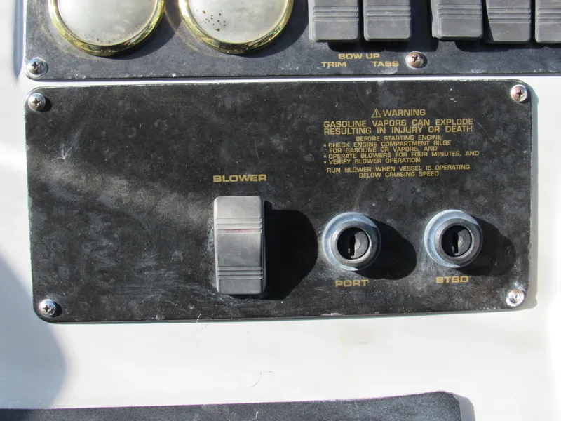 Slide: The Image of Control panel of a 2003 Cruisers Yachts 2870 Express with blower switches and safety warning. - 14
