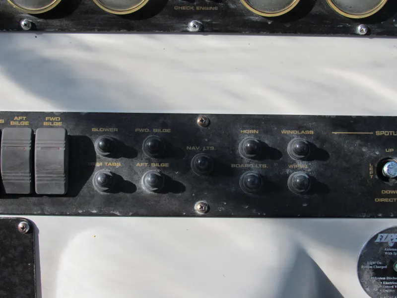 Slide: The Image of Control panel of 2003 Cruisers Yachts 2870 Express with various switches and gauges. - 16