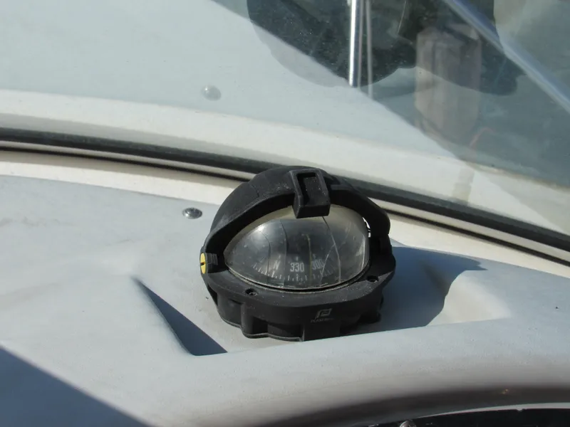 Slide: The Image of Compass on 2003 Cruisers Yachts 2870 Express dashboard, showing heading 330 degrees. - 19