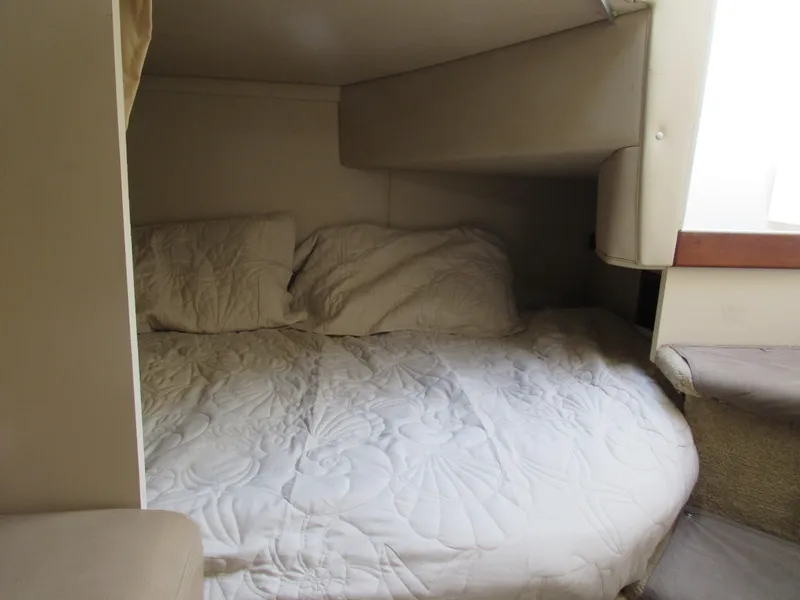 Slide: The Image of Cozy sleeping area in 2003 Cruisers Yachts 2870 Express with white bedding. - 35