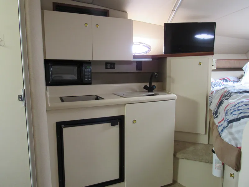 Slide: The Image of 2003 Cruisers Yachts 2870 Express interior with kitchenette and bed. - 36