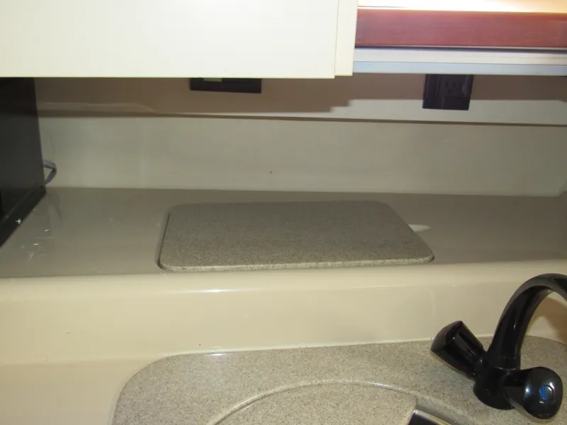 Slide: The Image of 2003 Cruisers Yachts 2870 Express kitchen area with countertop and faucet. - 41