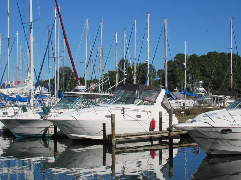 Slide: The Image of 2003 Cruisers Yachts 2870 Express docked in a marina with sailboats. - 5